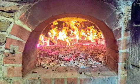 Die Glut im gemauerten Ofen erreicht bis zu 400 Grad, bevor die Brotlaibe ausgebacken werden können. (Foto: Christian Völkel) Die Glut im gemauerten Ofen erreicht bis zu 400 Grad, bevor die Brotlaibe ausgebacken werden können. (Foto: Christian Völkel)